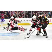 Binghamton Devils right wing Marian Studenic (27) shields the Cleveland Monsters while goaltender Cam Johnson dives into position