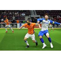Mississauga MetroStars' Mo Babouli (left) and Utica City FC captain Bo Jelovac fight for possession of the ball