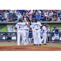 Tanner English of the Pensacola Blue Wahoos receives congratulations after his first inning grand slam