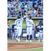 Travis Blankenhorn of the Pensacola Blue Wahoos receives congratulations after a home run
