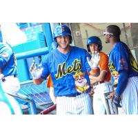 Tim Tebow reacts in the Syracuse Mets dugout to getting the silent treatment from his teammates after hitting his first career Triple-A home run
