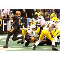 Davontae Merriweather of the Arizona Rattlers (left) rushes in to support Jarrod Harrington's tackle against the Tucson Sugar Skulls