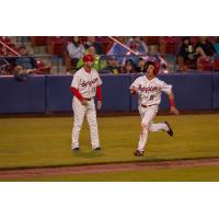 Spokane Indians second baseman Kenen Irizarry digs for home