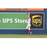 Spokane Indians leap for a catch at the wall
