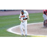 Deibinson Romero walks back to the dugout after scoring for the Long Island Ducks