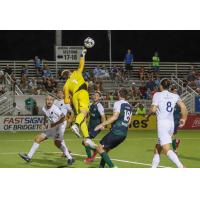 Memphis 901 FC goalkeeper Jeff Caldwell leaps high to swat a ball against Saint Louis FC