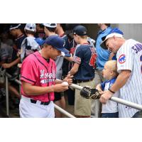 Jovani Moran of the Pensacola Blue Wahoos signs an autograph for a young fan