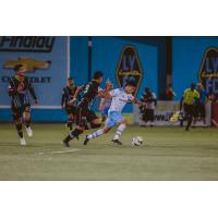 Sebastain Velasquez of El Paso Locomotive FC navigates past Las Vegas Lights FC