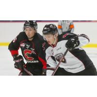 Vancouver Giants right wing Justin Lies (right) vs. the Prince George Cougars