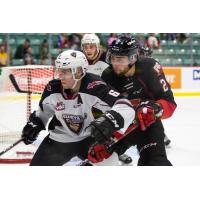 Vancouver Giants defenceman Dylan Plouffe fends off the Prince George Cougars