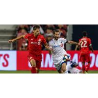 Toronto FC's Omar Gonzalez (L) and the Montreal Impact's Ignacio Piatti in the Canadian Championship