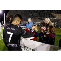 Colorado Springs Switchbacks FC forward Fernando Gonzalez Delfin greets young fans