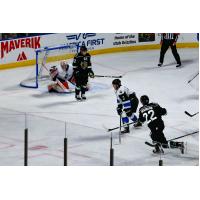 Utah Grizzlies forward Josh Dickinson (lower right) snaps off a shot against the Wichita Thunder