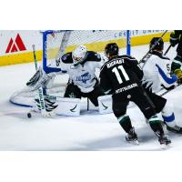 Utah Grizzlies defenseman Taylor Richart (11) eyes a puck in front of the Idaho Steelheads goal