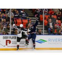 Jackson Shepard of the Vancouver Giants collides with a Tri-City Americans player along the boards