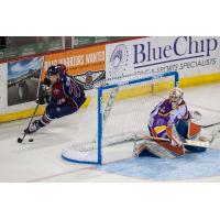 Tulsa Oilers forward Ryan Tesink handles the puck behind the Wichita Thunder net