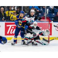 Kelowna Rockets defenceman Jake Lee (right) vs. the Saskatoon Blades