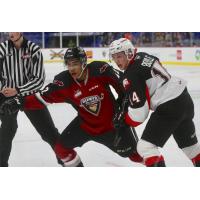 Vancouver Giants centre Justin Sourdif (left) vs. the Prince George Cougars