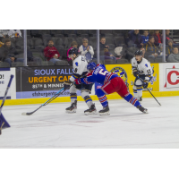 Sioux Falls Stampede forward Cameron MacDonald (left) vs. the Des Moines Buccaneers