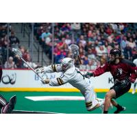 Vancouver Warriors forward Jordan McBride lunges to take a shot against the Colorado Mammoth