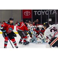 Kelowna Rockets defense sets up in front of goaltender Cole Schwebius