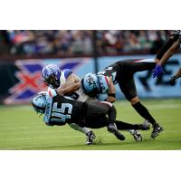 Dallas Renegades defenders Doyin Jibowu and Josh Thornton bring down a St. Louis BattleHawks ballcarrier