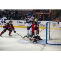 Tulsa Oilers forward Adam Pleskach (center) vs. the Rapid City Rush