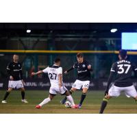 Tacoma Defiance midfielder Christopher Hegardt (right) challenges for possession against Reno 1868 FC