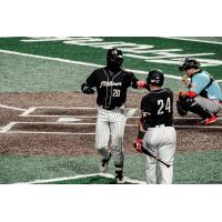 Milwaukee Milkmen outfielder Adam Brett Walker (20) receives congratulations from catcher Christian Correa