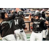 Milwaukee Milkmen exchange congratulations during Game 1 of the American Association Championship Series