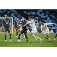 Chicago Fire FC vie for possession against Minnesota United