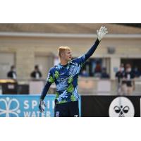 Forward Madison FC goalkeeper Chris Brady