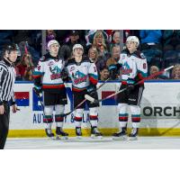 Kelowna Rockets forward Pavel Novak (centre) and defenceman Kaedan Korczak (right)