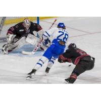 Rapid City Rush goaltender David Tendeck prepares to stop Dean Stewart of the Wichita Thunder