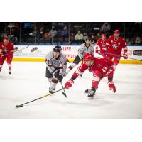 Allen Americans defenseman Matt Register (right) vies for the puck vs. the Kansas City Mavericks