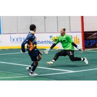 Florida Tropics goalkeeper Hugo Silva faces a shot from the Tacoma Stars' Jamael Cox