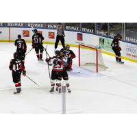 Jake Poole (23) and Dylan Wrightman of the Kelowna Rockets react after a goal against the Prince George Cougars