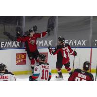 Vancouver Giants left wing Zack Ostapchuk (left) and centre Justin Sourdif celebrate a goal vs. the Kelowna Rockets