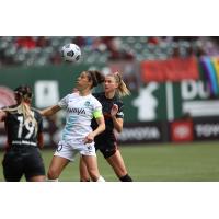 Carli Lloyd of NJ/NY Gotham FC (center) battles Crystal Dunn (left) and Kelli Hubly of the Portland Thorns