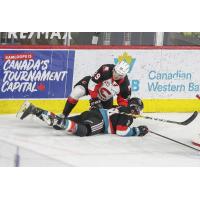 Prince George Cougars defenseman Majid Kaddoura takes down Jake Lee of the Kelowna Rockets