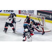 Prince George Cougars defend against the Kelowna Rockets
