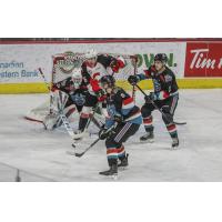 Prince George Cougars right wing Michael Svenson in a swarm of Kelowna Rockets