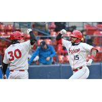 Spokane Indians outfielder Niko Decolati (right) prepares for an elbow bump from infielder Michael Toglia