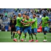 Seattle Sounders FC forward Raúl Ruidíaz receives congratulations from his teammate