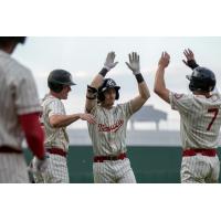Kansas City Monarchs Ryan Grotjohn celebrates after one of his two home runs with teammates Casey Gillaspie and #7 Colin Willis