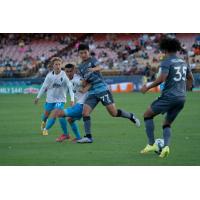 Tacoma Defiance midfielder Sota Kitahara (center) and defender Alex Villanueva (right) battle Las Vegas Lights FC