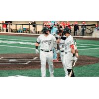 Milwaukee Milkmen catcher Christ Conley (left) and infielder Anibal Sierra