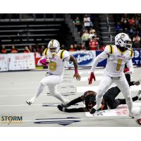 Sioux Falls Storm quarterback Lorenzo Brown with the ball as Damian Ford looks to make a block against the Bismarck Bucks