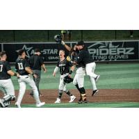 Milwaukee Milkmen celebrate an extra-innings win