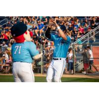 Nick Yovetich of the St. Cloud Rox high fives Chisel, the team mascot